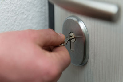 Cropped hand of person holding key