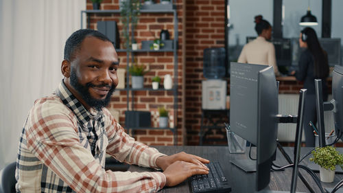 Portrait of smiling businessman working in office