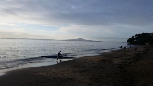 Man standing on beach against sky