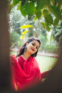 Portrait of a smiling young woman standing outdoors