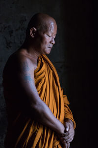 Side view of man against black background