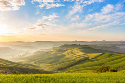 Sunrise with fog in the rolling landscape