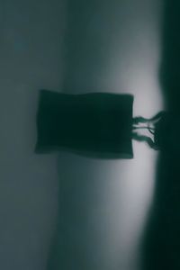 Close-up of shadow on water against wall