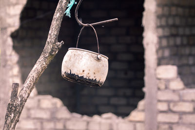 Close-up of rusty metal hanging against wall