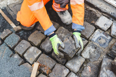 Low section of man standing on footpath