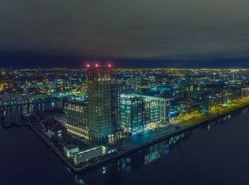 Aerial view of illuminated buildings in city at night