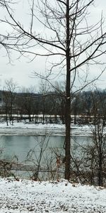 Scenic view of frozen lake against sky during winter