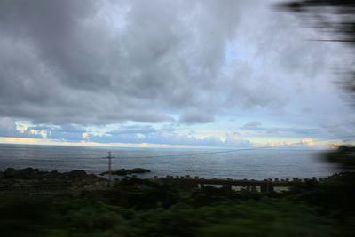 Scenic view of sea against cloudy sky