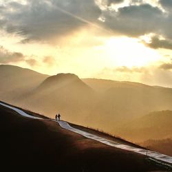 Scenic view of mountains against cloudy sky