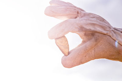 Close-up of human hand against white background