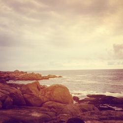 Scenic view of sea and rocks against sky