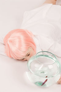 Woman looking at fish in bowl