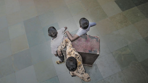 High angle view of man standing on tiled floor