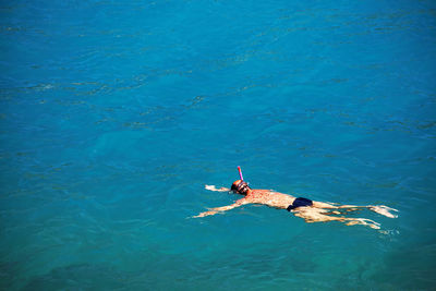 High angle view of man swimming on sea