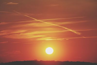 Scenic view of silhouette landscape against orange sky
