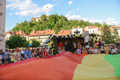 People on street in city against sky