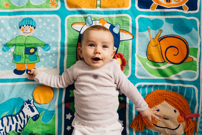 High angle view of baby girl lying on bed at home