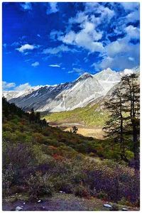 Scenic view of mountains against cloudy sky