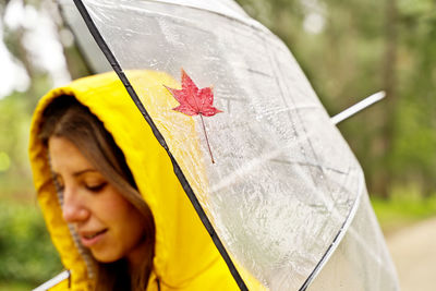 Woman holding umbrella at park