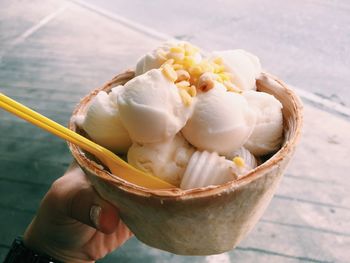 Close-up of hand holding ice cream cone