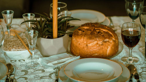 High angle view of food and wineglasses arranged on table 