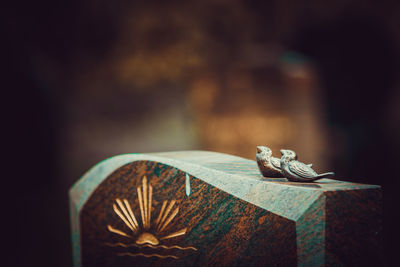 Close-up of cross on table