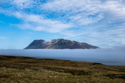 View of volcanic landscape against cloudy sky