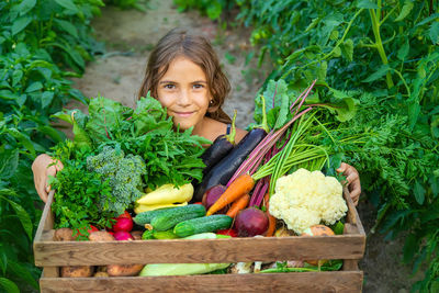 Portrait of woman picking vegetables