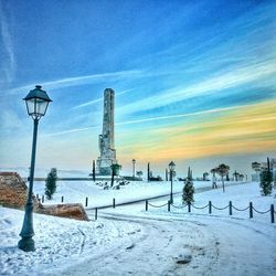 Scenic view of snow covered landscape at sunset