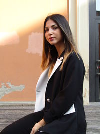 Portrait of beautiful young woman standing outdoors