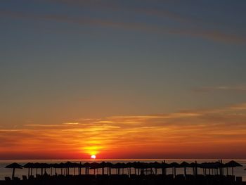 Silhouette bridge against sky during sunset