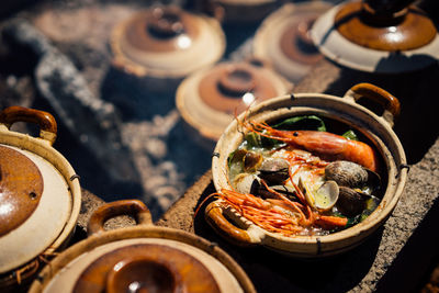 High angle view of seafood in container on stove