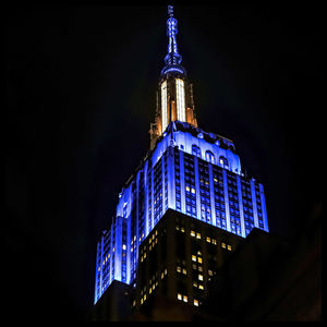 Low angle view of illuminated building against sky at night