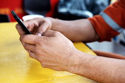 Close-up of man holding mobile phone