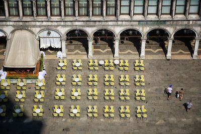 People with flowers in front of building