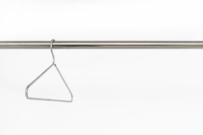 Close-up of empty hanging over white background