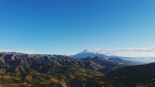 Scenic view of mountains against clear blue sky