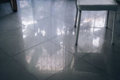 Reflection of building on tiled floor