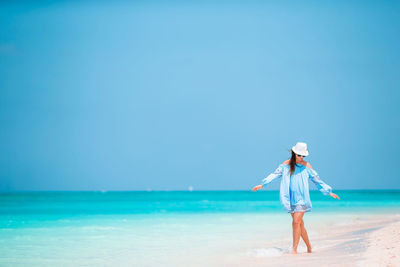 Full length of woman standing on beach