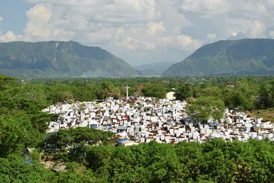Cemetery by mountains against sky
