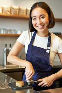 Portrait of smiling young woman using mobile phone