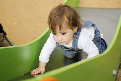 High angle view of cute boy on slide