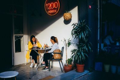 Woman sitting on chair at table