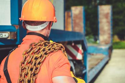 Rear view of man working in bus