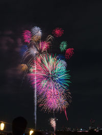 Low angle view of firework display at night