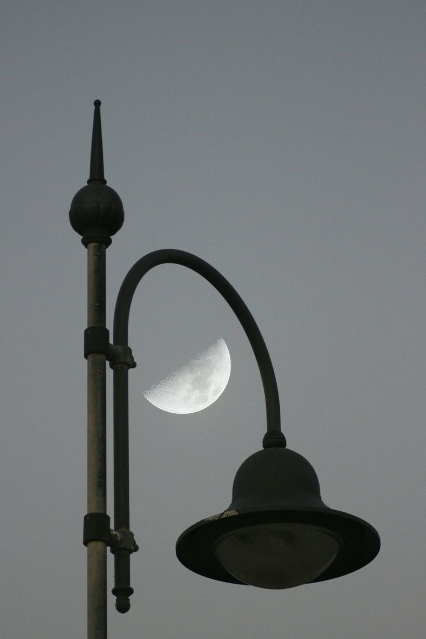 low angle view, lighting equipment, street light, clear sky, built structure, copy space, architecture, sky, sphere, lamp post, metal, electricity, light bulb, electric lamp, communications tower, no people, electric light, outdoors, pole, close-up