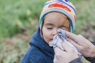 Close-up portrait of cute boy with eyes closed