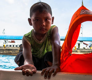 Portrait of boy in swimming pool against sky
