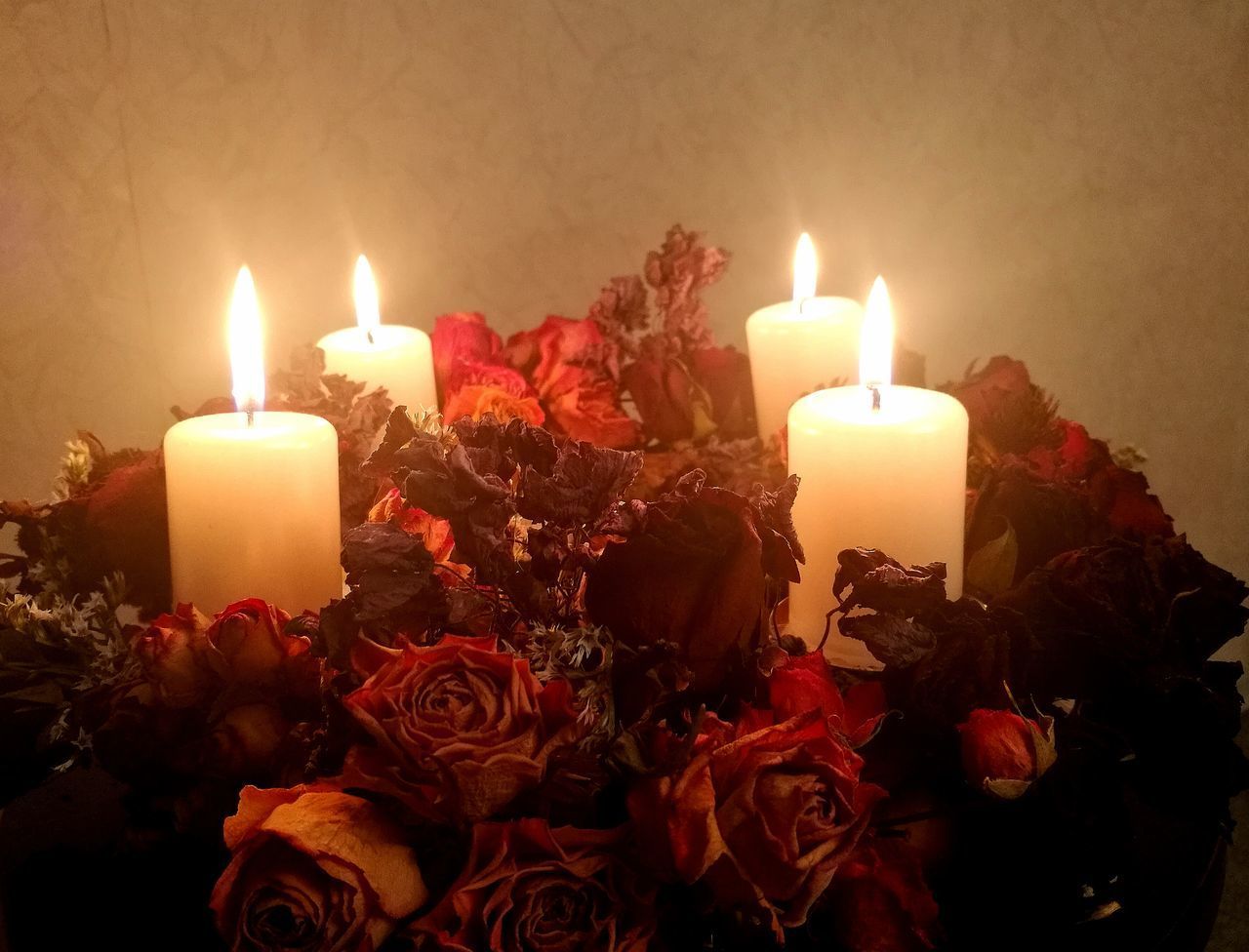 CLOSE-UP OF ILLUMINATED CANDLES BURNING