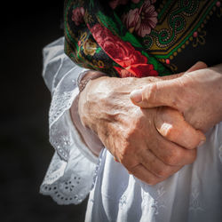 Midsection of senior woman outdoors